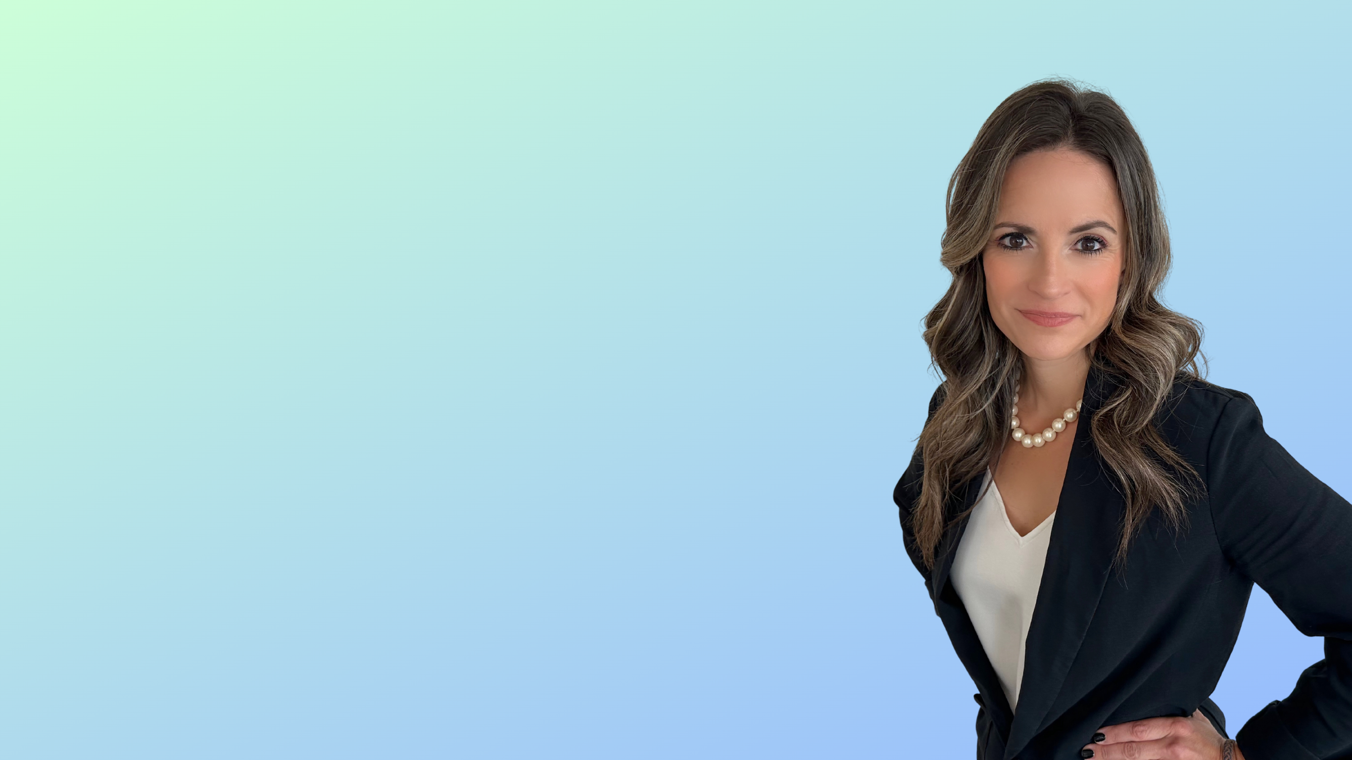 a woman in a black blazer against a blue background.